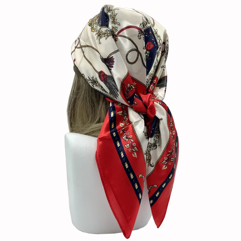 A large silk print shawl featuring red, white, and blue patterns with floral and feather motifs.