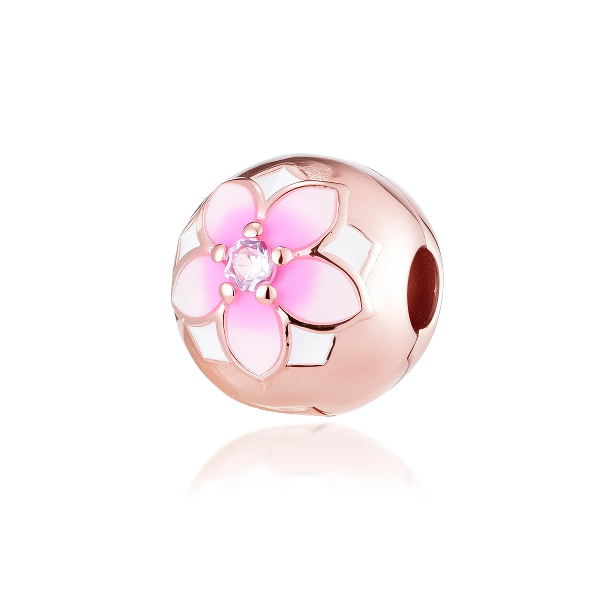 Una cuenta redonda con diseño de flor rosa, centro transparente y acentos blancos.