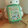 A light green tinplate candy box with a carrying loop featuring cute panda characters and food items, held by a white stuffed