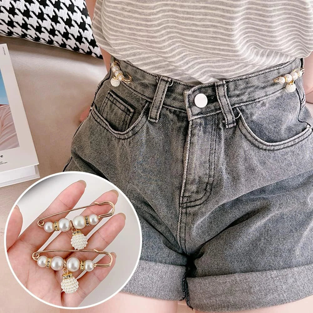 A pair of gray denim shorts is shown alongside a hand displaying heavy duty pearl safety pins for clothing.