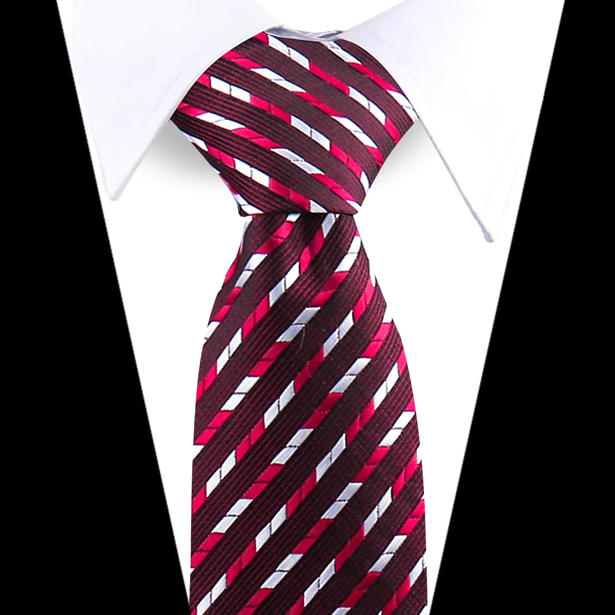 A close-up of a maroon and white striped silk necktie worn under a white dress shirt.