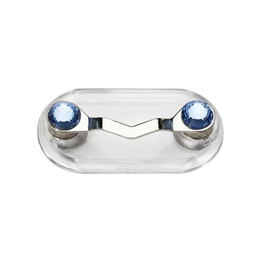 A clear plastic magnetic clip designed to hold eyeglasses, featuring two blue decorative elements.