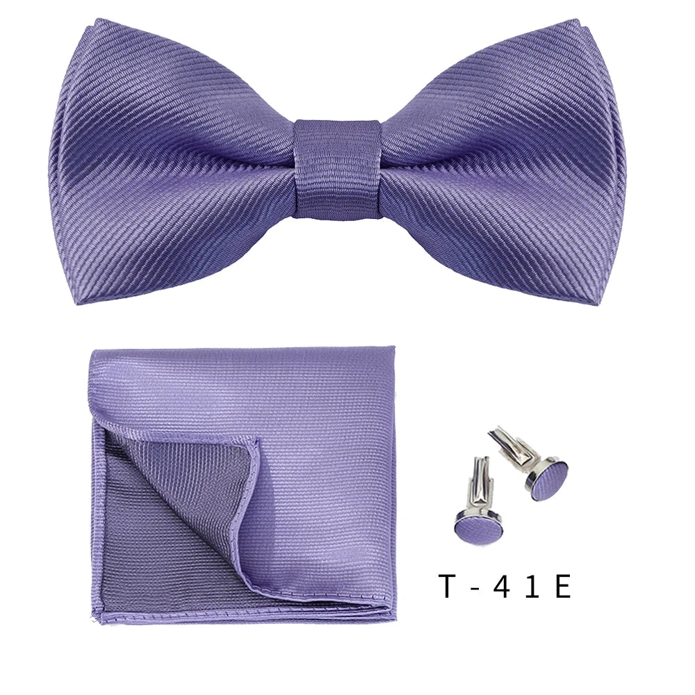 A purple bow tie and cufflink set displayed on a white background.