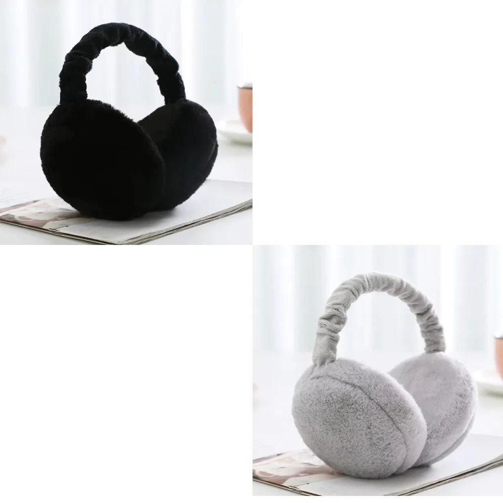 A pair of black plush fur ear warmers or earmuffs resting on a white surface.