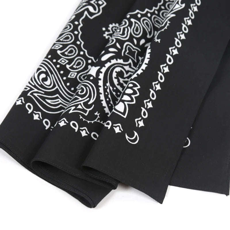 Black paisley bandana scarf featuring white intricate patterns and stars