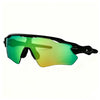 A pair of green-tinted cycling sunglasses with a black frame shown against a white background.