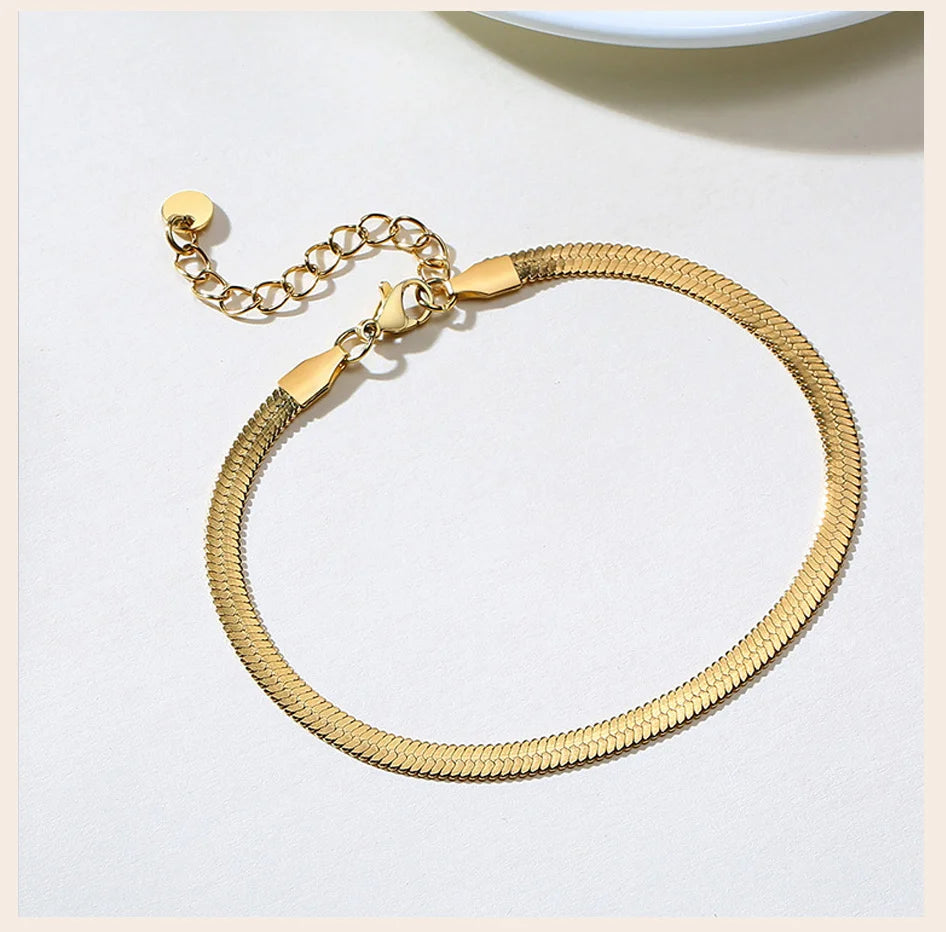 Gold stainless steel snake chain anklet bracelet with a lobster clasp and chain.