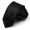 A black satin neck tie is shown folded and draped on a white background.