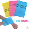 A set of five exfoliating bath washcloths in yellow, pink, and blue with black stripes shown next to a hand.