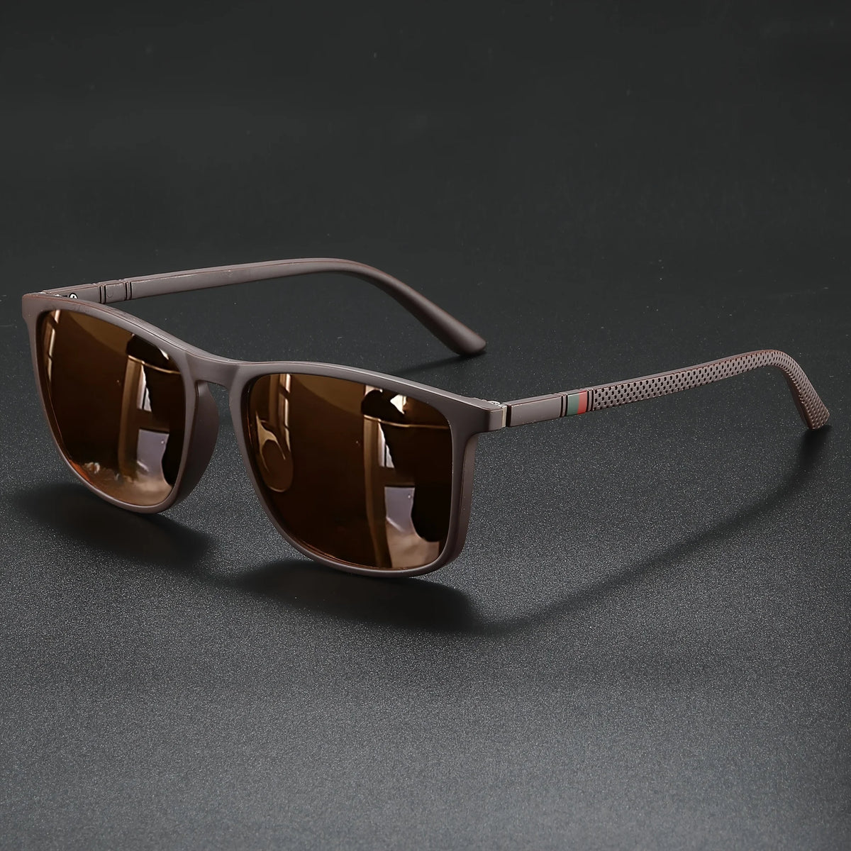 Brown-tinted classic square sunglasses with a matte brown frame resting on a dark surface.