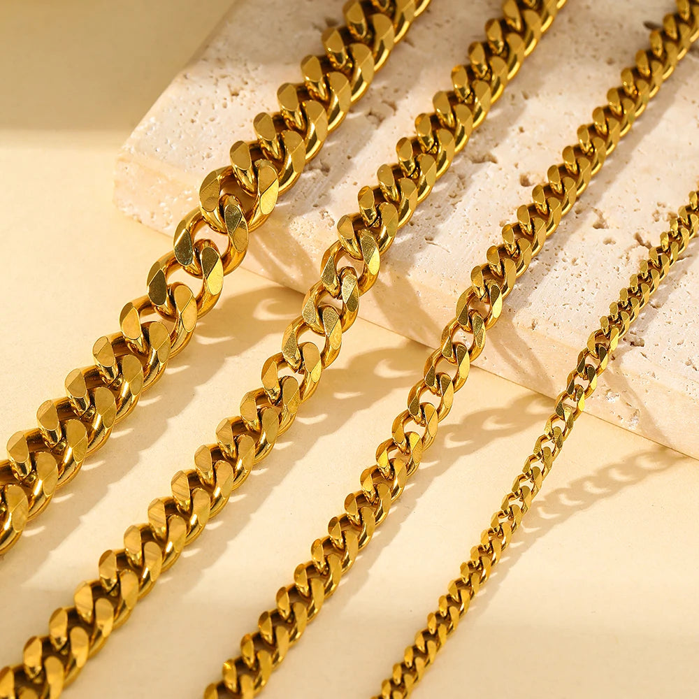Gold stainless steel multi-chain anklets laid out on a light surface.