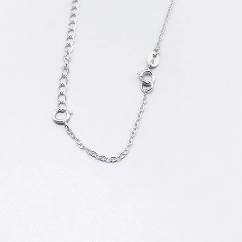 A delicate silver extension chain necklace with small jump rings for jewelry making.