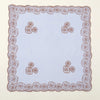 A square piece of light purple fabric with a detailed floral embroidered lace border.