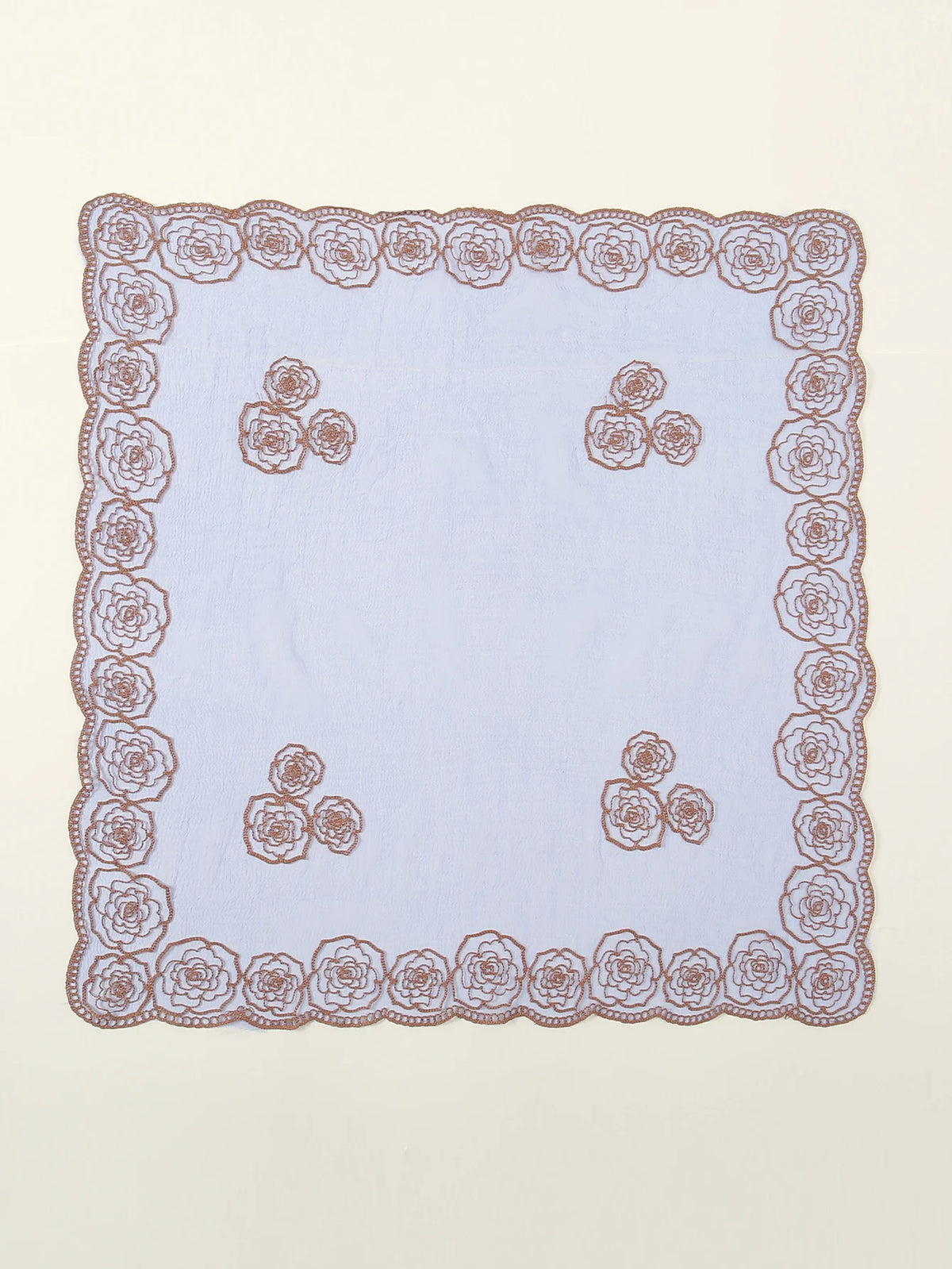 A square piece of light purple fabric with a detailed floral embroidered lace border.
