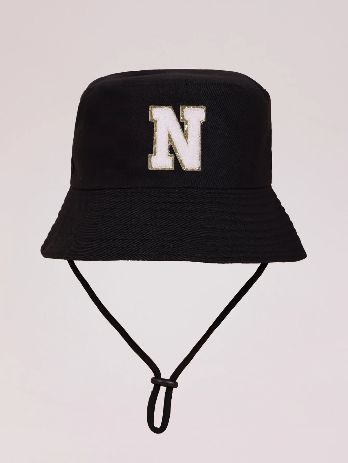 Black sun hat with a white letter N embroidered on the front and an adjustable cord.