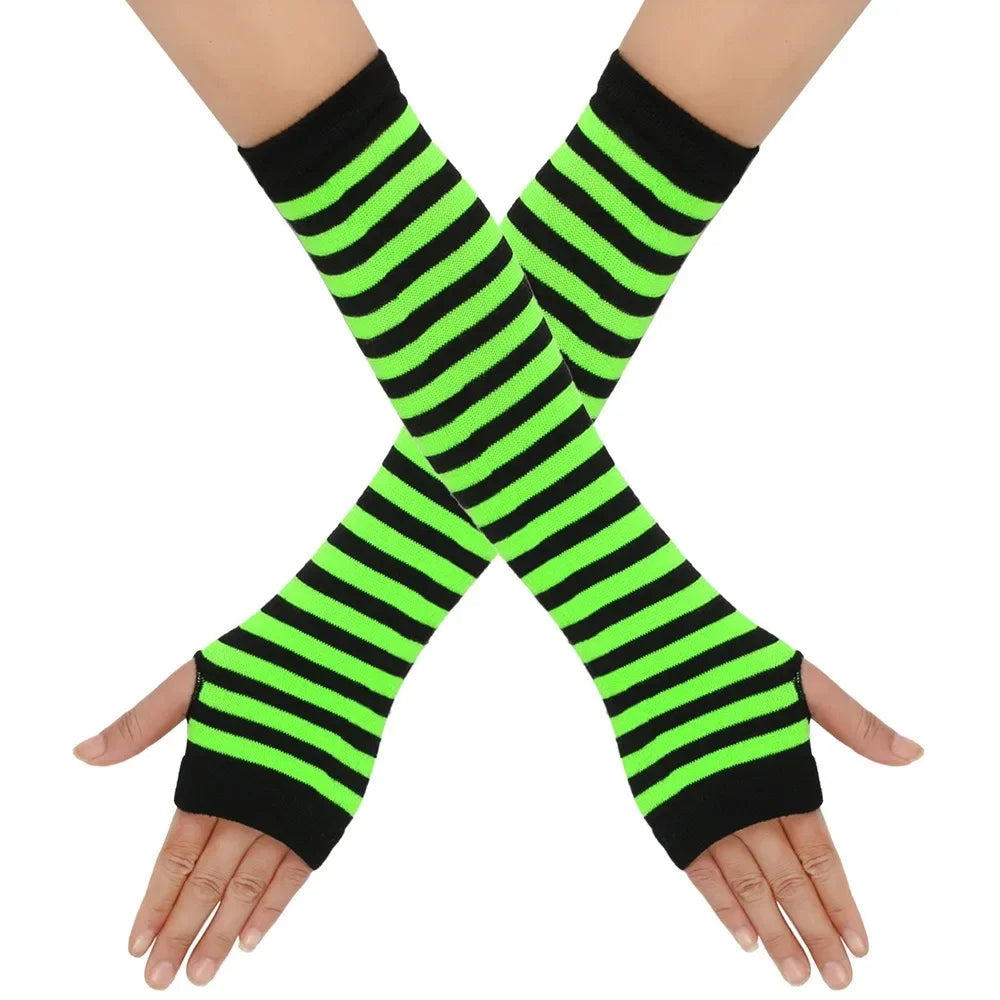 A pair of neon green and black striped knitted fingerless gloves crossed on a hand.