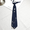 Navy blue tie with a silver star pendant and chain detail