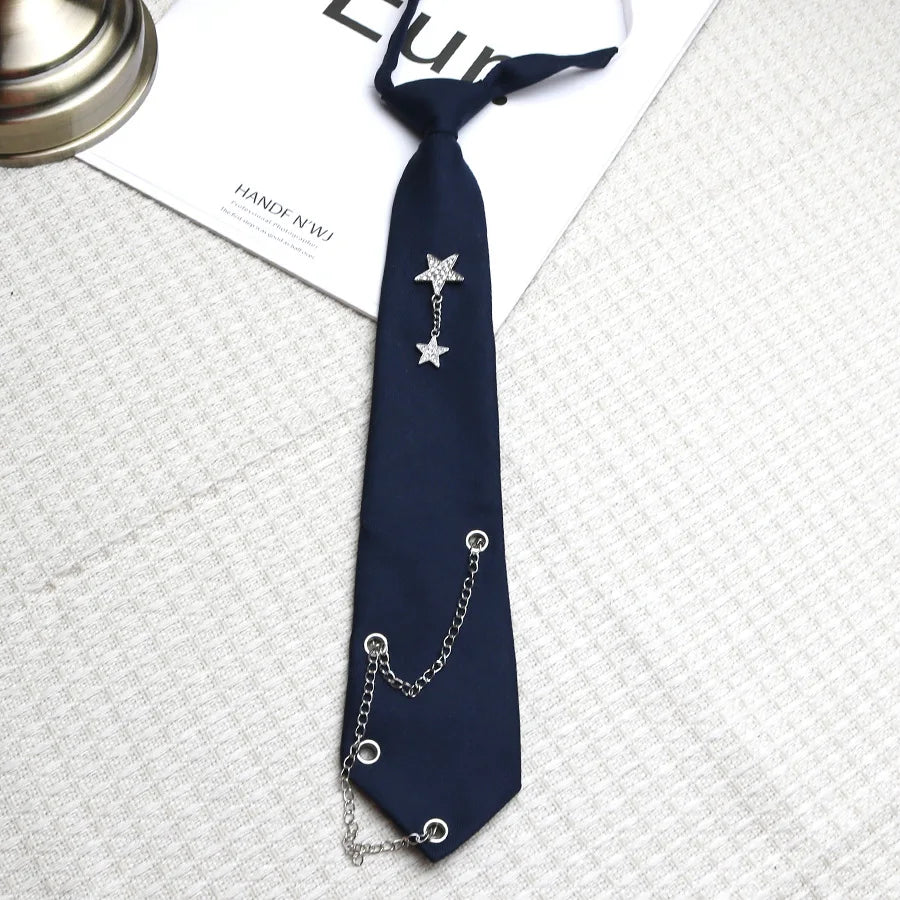 Navy blue tie with a silver star pendant and chain detail