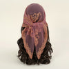 A deep purple floral embroidered lace bandana headscarf tied around dark hair.
