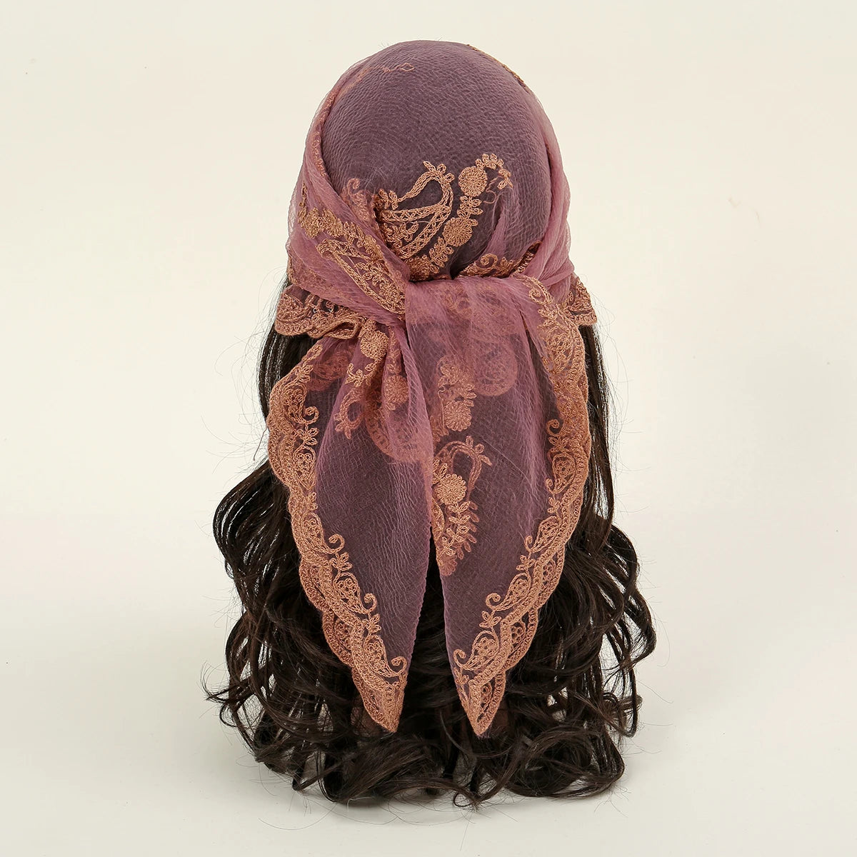 A deep purple floral embroidered lace bandana headscarf tied around dark hair.
