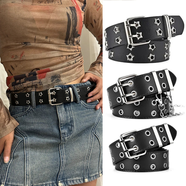 Black leather adjustable belt with silver buckles and star studs worn over a denim skirt.