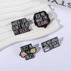 Black enamel lapel pins featuring literary quotes like When I Die Don't Read My Books and I Did Not Judge The Book By Its Mov