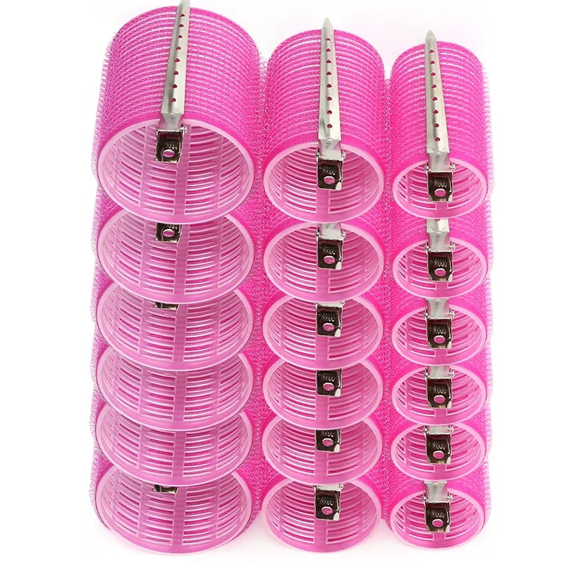 A set of pink heatless hair curlers for DIY styling, showing various sizes and attachments.