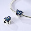 Sterling silver devil's eye charm bracelet featuring a heart pendant with blue and gold eye motifs