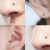 Close-up photos showing magnetic nose stud earrings in gold tone with cubic zirconia stones.
