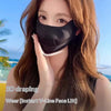 A woman models a black draping face mask for an instant V-line face lift treatment.