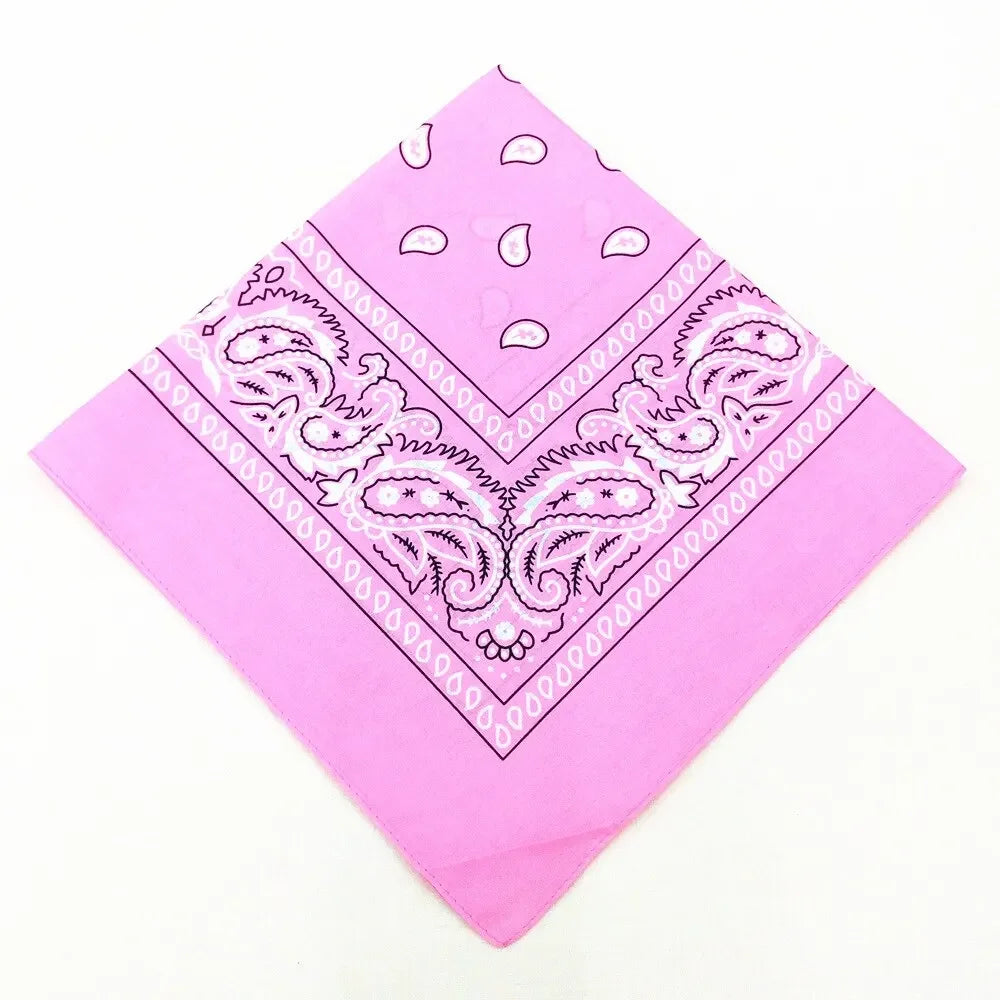 Pink bandana featuring intricate white paisley and geometric patterns for a headband or wrist wrap set