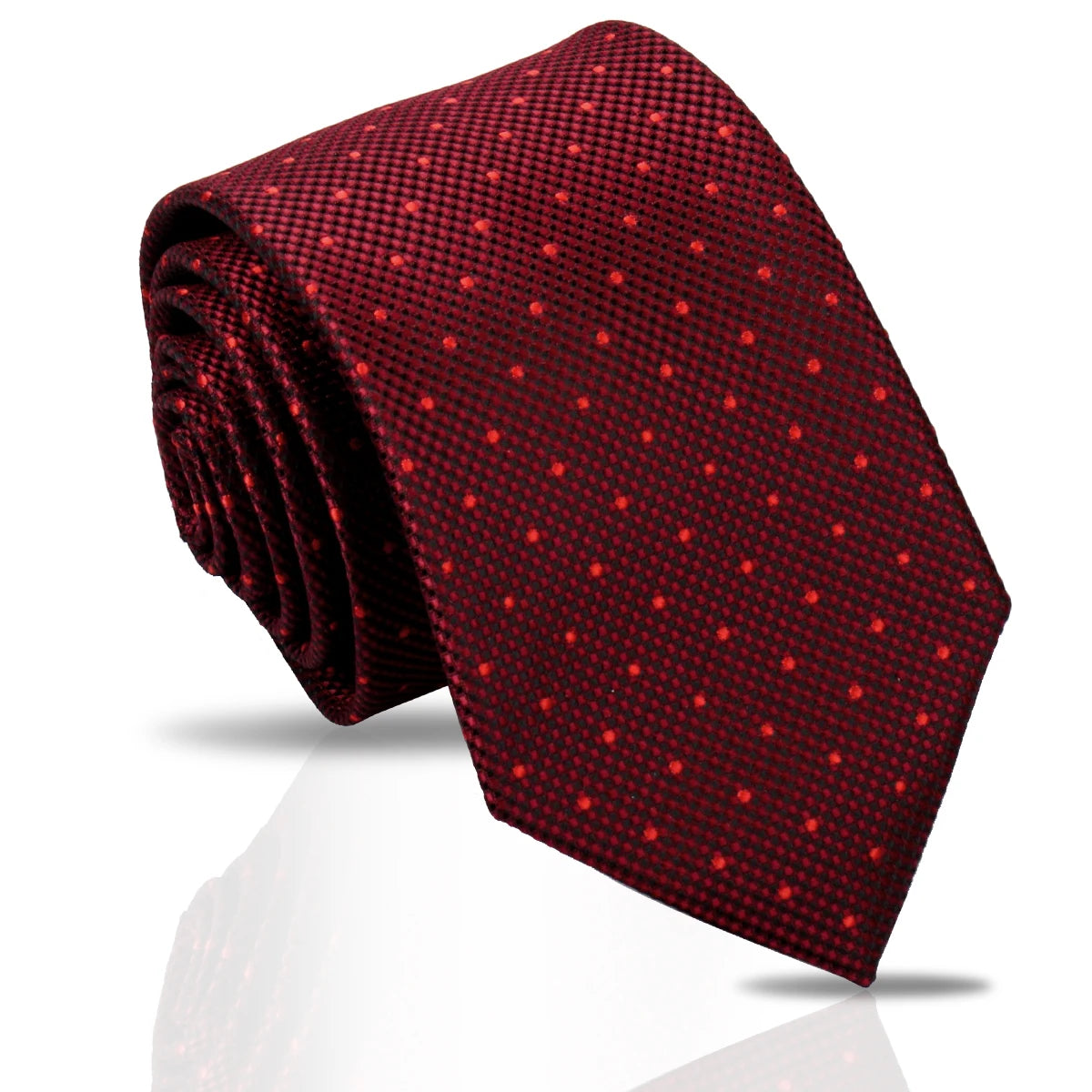 A deep red patterned silk necktie rolled and displayed on a reflective surface.