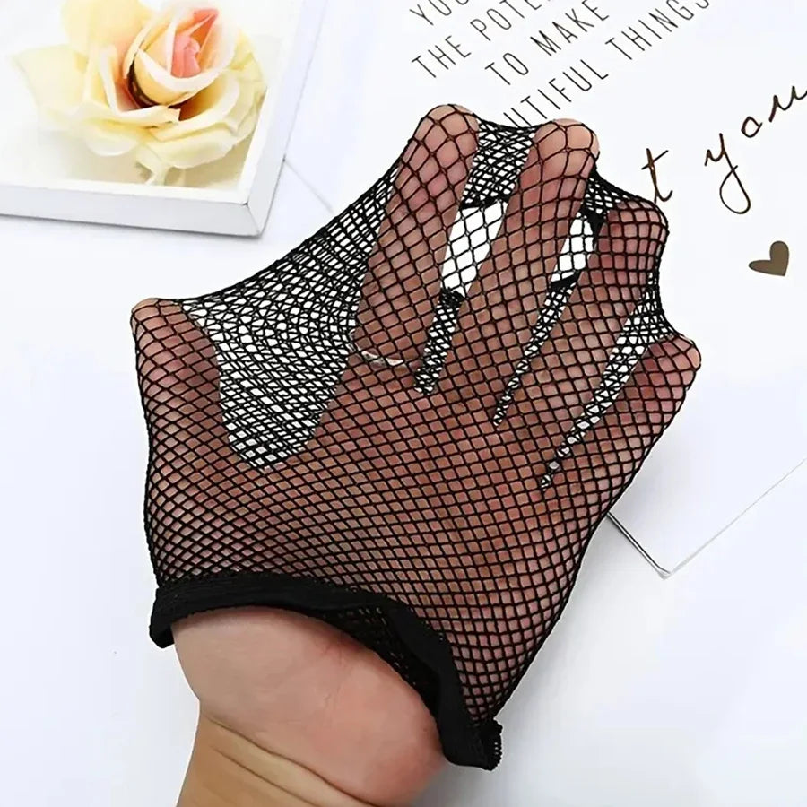 A hand is wearing a black fishnet glove or fingerless sleeve on the fingers, displayed next to a white card.