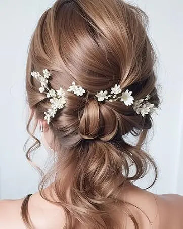 A close-up of a woman's hair styled in an elegant updo using brown hair and clear bobby pins.