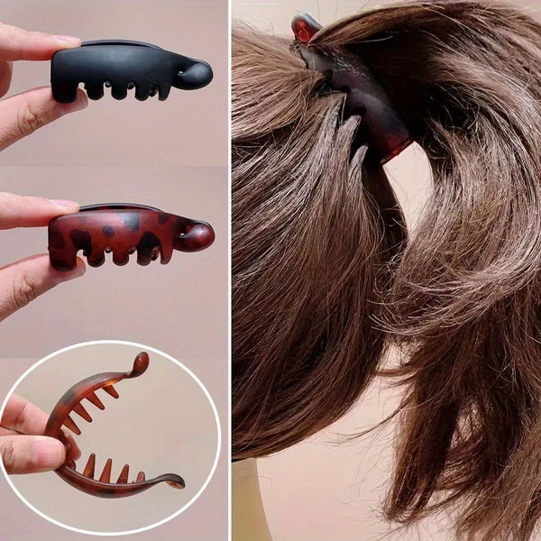 A set of four banana clips in various shades of brown and black used to secure hair