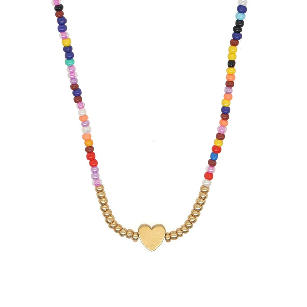 A necklace featuring a colorful beaded bohemian heart pendant on a gold chain.