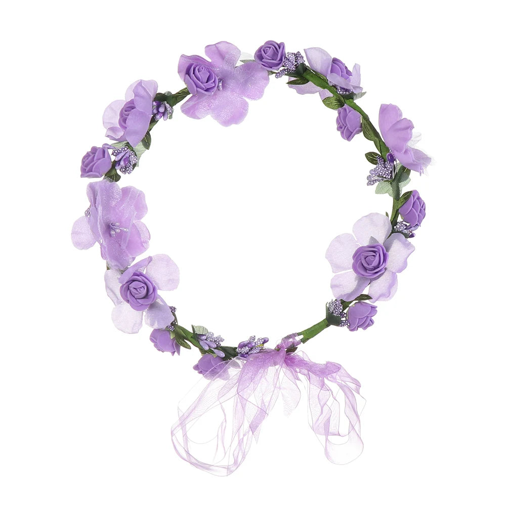 A purple and lavender floral wreath headband made of small flowers and accented with sparkly purple tulle.