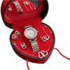 A red velvet jewelry box containing a rhinestone heart-shaped women's jewelry set including a watch and necklaces.