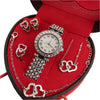 A red jewelry box containing a rhinestone heart-shaped women's jewelry set including a watch and necklaces.