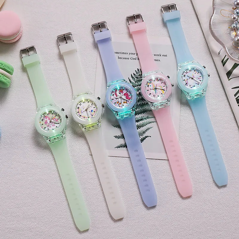 A collection of pastel-colored unicorn fashion watches for girls and women displayed on a white surface.
