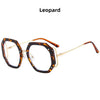 A pair of leopard print eyeglasses with gold-toned frames.