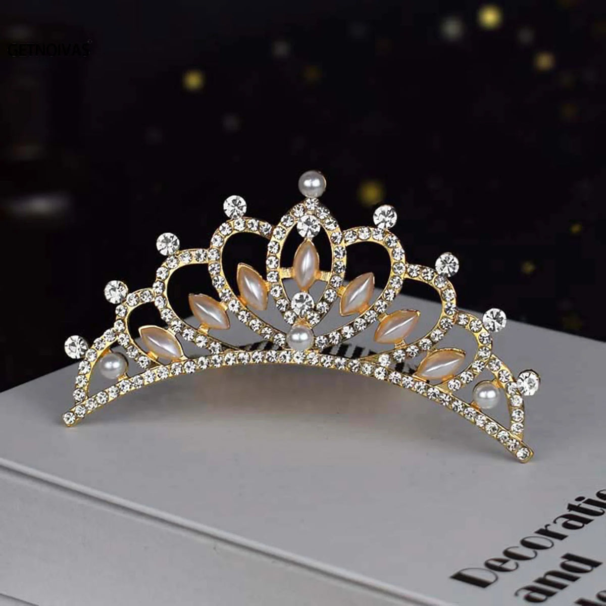 A sparkling crystal princess tiara hair comb for women with pearl accents displayed on a white box.