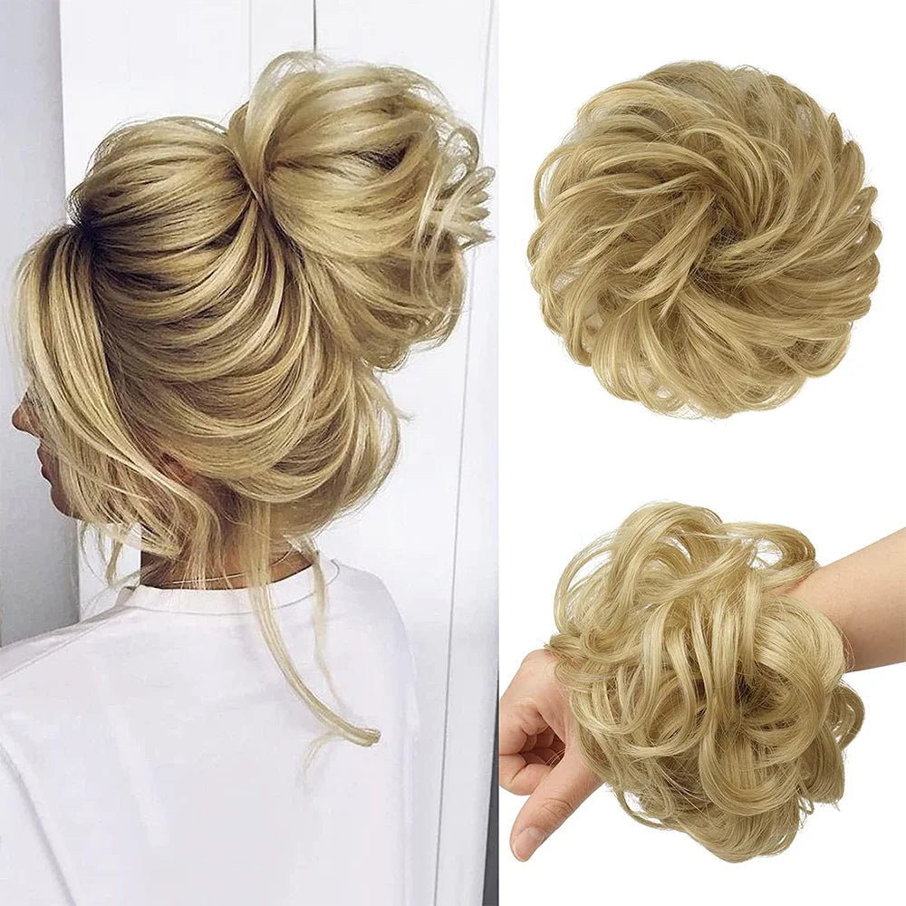 A blonde woman shows off a styled messy bun hairstyle with loose curls and hair pieces.