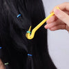 A hand is using a yellow tool to remove an elastic or rubber band from black hair.