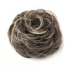 A messy bun hairstyle made from dark brown and gray hair