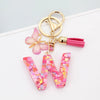 Alphabet letter W acrylic keychain with pink butterfly and tassel