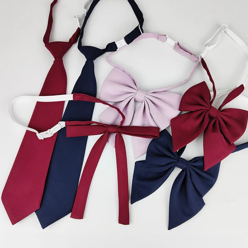 A set of classic butterfly ribbon ties in maroon, navy blue, and light pink are displayed against a white background.