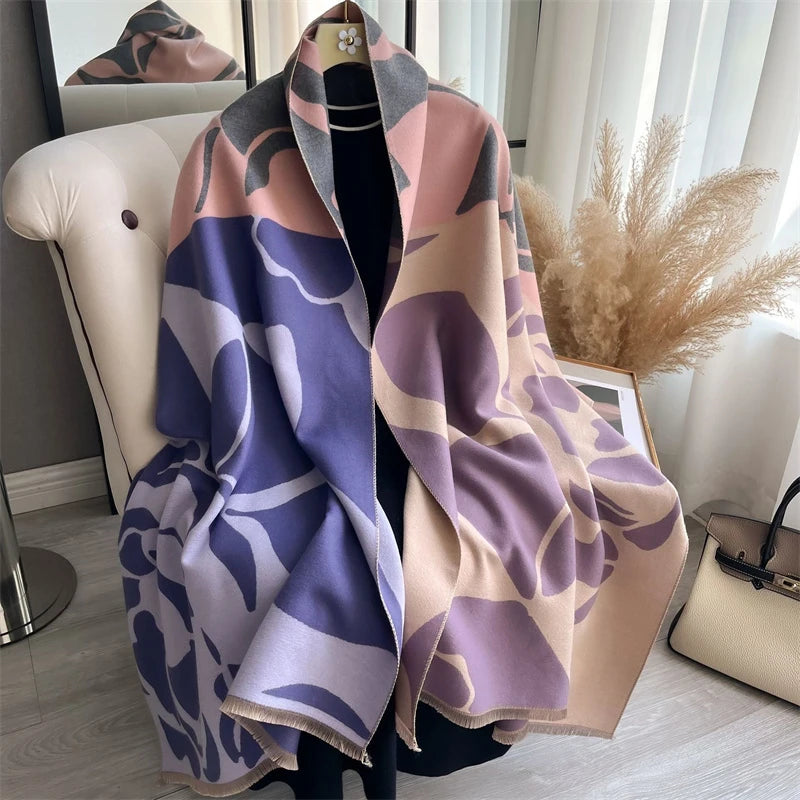 A draped luxury plaid cashmere feel scarf and shawl wrap in shades of mauve, purple, and beige.