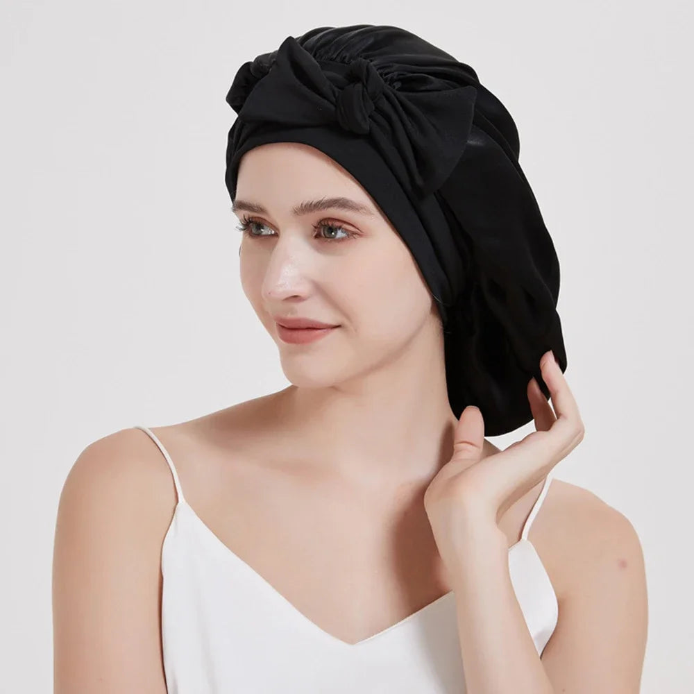 A woman wearing a black Mulberry Silk Sleep Bonnet for Curly Hair