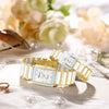 A pair of gold and silver luxury quartz couple watches resting on a light surface with soft floral background.